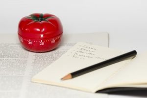 tomato ktchen timer, notebook, pencil, article